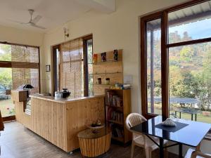 a kitchen with a counter and a table and chairs at Lake 1 Estate in Morni