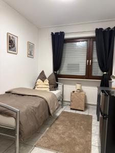 a bedroom with a bed and a window at Gaststätte Seehaus Maroth in Maroth