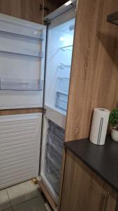 an empty refrigerator with its door open in a kitchen at Apartment 1 at Busy Bee in Daingean +50 photos