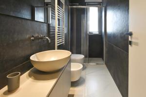 a bathroom with a bowl sink and a toilet at LifeStyle Boutique Apartment in Monopoli +35 photos