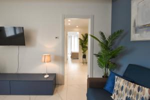 a living room with a couch and a plant at LifeStyle Boutique Apartment in Monopoli