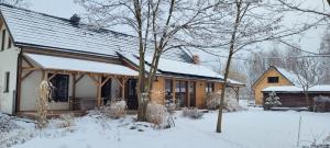 a house with snow on the roof at Esterka Village in Esterka