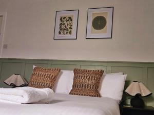 a bedroom with a bed with white sheets and pillows at Saint Margaret's Guest House - Comfortable Rooms in a Quiet Area Close to the Heart of Poole - Free Parking & Fast Wifi in Poole