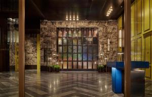 a lobby of a building with a stone wall at Andaz Shanghai ITC in Shanghai +82 photos