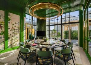a dining room with a table and chairs and a chandelier at Andaz Shanghai ITC in Shanghai