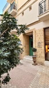 a building with a green door and a potted plant at Centrum Hotel - City Center in Nicosia