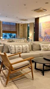 a living room with a large couch and tables at Centrum Hotel - City Center in Nicosia