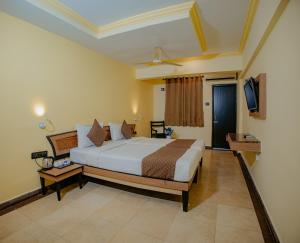 a bedroom with a large bed and a television at Om Shiv Hotel Formerly The Treat Hotel in Madgaon +75 photos