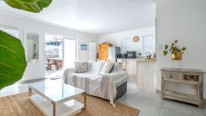 a living room with a couch and a table at Huis Marais in Herolds Bay