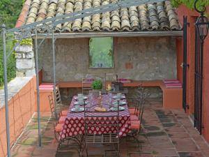 a table and chairs in an outdoor patio at Magnificent farmhouse with private pool and garden in Roussières