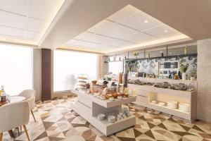 a kitchen with a counter with food on it at Foxtrail Sector 60 - AM Hotel Kollection, Gurgaon in Gurgaon
