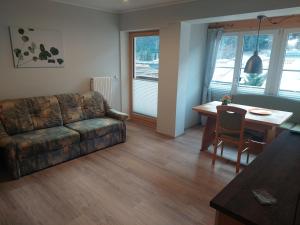 a living room with a couch and a table at Haus Holzer in Dorfgastein