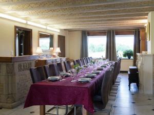 a long dining room with a long table and chairs at Spacious and well cared for house with a panoramic in Habiemont