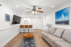 a living room with a couch and a ceiling fan at Atlanta North Urban Chic 2BR- 7th Floor in Atlanta +8 photos