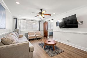 a living room with a couch and a flat screen tv at Atlanta North Urban Chic 2BR- 7th Floor in Atlanta