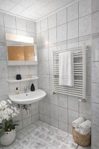 a white bathroom with a sink and a shower at SK Ferienapartments Kappelrodeck in Kappelrodeck +40 photos