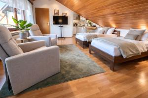 a large living room with two beds and a couch at SK Ferienapartments Kappelrodeck in Kappelrodeck