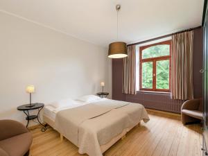 a bedroom with a large bed and a window at A beautifully renovated mansion in the Ardennes in Vielsalm