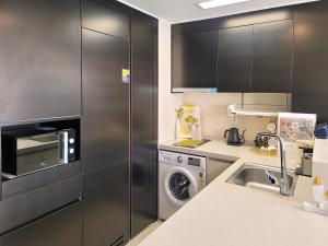 a kitchen with a stainless steel refrigerator and a dishwasher at 오늘도광안씨 in Busan