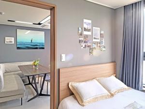 a bedroom with a table and a bed and a dining room at 오늘도광안씨 in Busan +22 photos