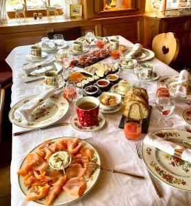 a table with plates of food on a table at Hollhouse - Bed & Breakfast in Hinterzarten