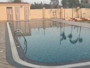 a large swimming pool in a building at Agastya Resort in Bāri