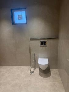 a bathroom with a toilet and a window at Agastya Resort in Bāri +21 photos