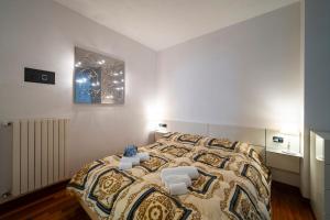 a bedroom with a bed with two chairs on it at PROMENADE Luxury View in Sarnico