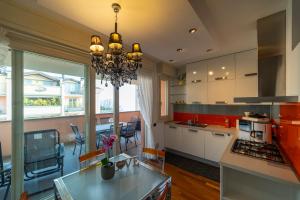 a kitchen with a chandelier hanging from the ceiling at PROMENADE Luxury View in Sarnico