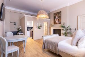 a bedroom with a bed and a dining room at 38 Bide Collective in Edinburgh
