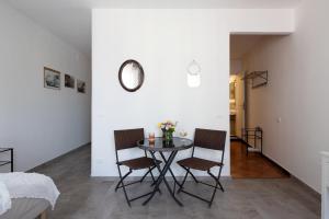 a dining room with a table and two chairs at EvasRooms Open space in Vernazza