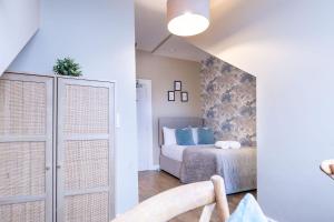 a bedroom with a bed with blue pillows at 38 Bide Collective in Edinburgh