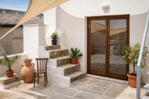 a patio with stairs and potted plants at Palazzo Luceri in Galatina +42 photos