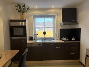 a kitchen with a sink and a window at Ferienwohnung Zaglmann in Zandt +10 photos