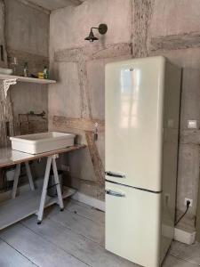 a white refrigerator in a kitchen with a sink at Ferienwohnung "Atelier_1" in Edenkoben