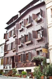 a building with shuttered windows and plants on it at Asmali Hotel in Istanbul