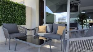 a patio with two chairs and a glass table at Protaras Heights- Hana in Paralimni