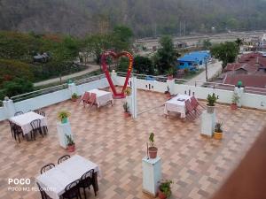 an outdoor area with tables and a roller coaster at Domukha pali ghar in Chepti