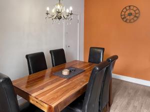 a dining room with a wooden table and black chairs at Moat House 6 - Ukc4889 in Fort Augustus