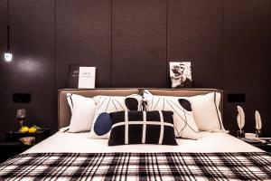 a bedroom with a bed with black and white pillows at Shanghai Hills&Rais Apartment - 100-inch Projector - Near Nanjing Road Pedestrian Street in Shanghai