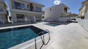 a swimming pool in the backyard of a house at Protaras Heights- Hana in Paralimni