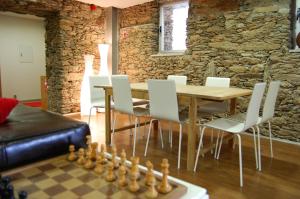 a table and chairs with a chessboard in a living room at Quinta dos Castanheiros - Turismo Rural in Negreda