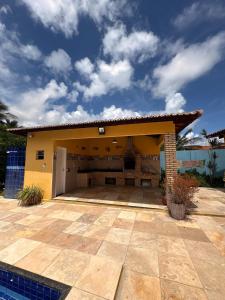 a house with a large patio in front of it at Caponga Beach House - 100m da Praia in Cascavel