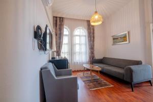a living room with a couch and a chair at The Diplomat Hotel in Turunç