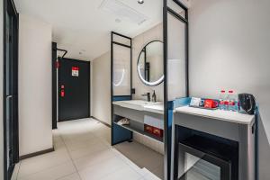 a bathroom with a sink and a mirror at Ibis Beijing Tiananmen Square in Beijing +32 photos