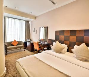 a hotel room with a bed and a desk at Ayass Hotel in Amman +49 photos