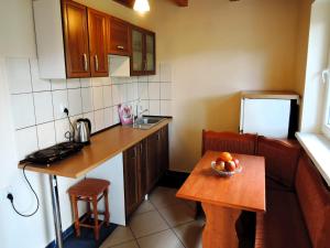 a small kitchen with a table with a bowl of fruit on it at Holiday House in Szczecin at the lake with parking space for 4 persons in Szczecin