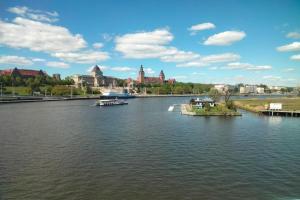 a river with two boats in the middle of a city at Holiday House in Szczecin at the lake with parking space for 4 persons in Szczecin
