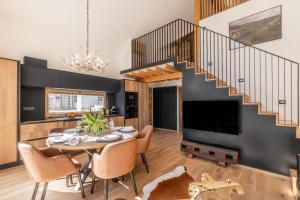 a dining room with a table and a staircase at Chalet Bela in Bohinjska Bela