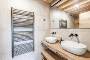 a bathroom with two sinks and a mirror at Chalet Bela in Bohinjska Bela +13 photos